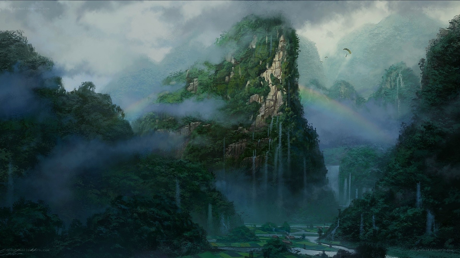 Misty mountain valley with rainbow