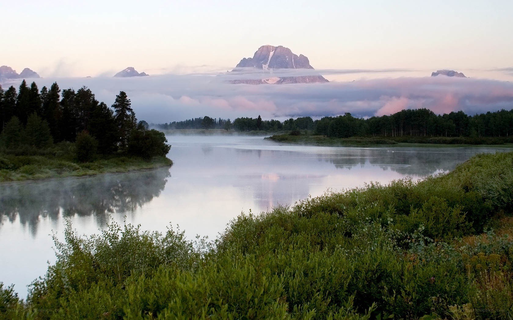 Misty river at dawn with mountains