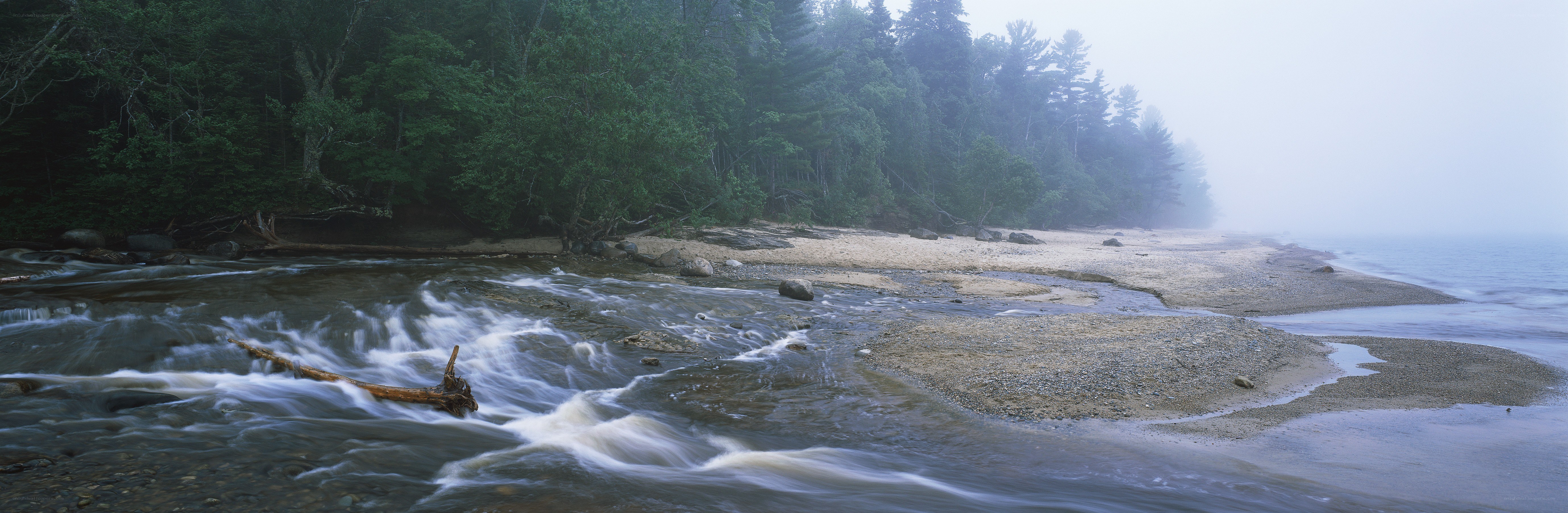 Misty river flowing into the sea