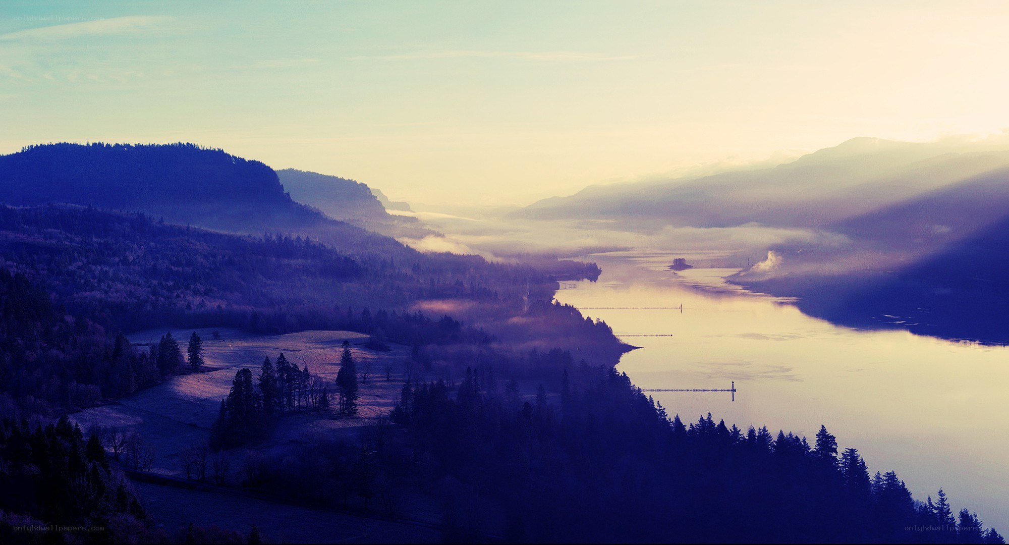 Misty river valley at dawn