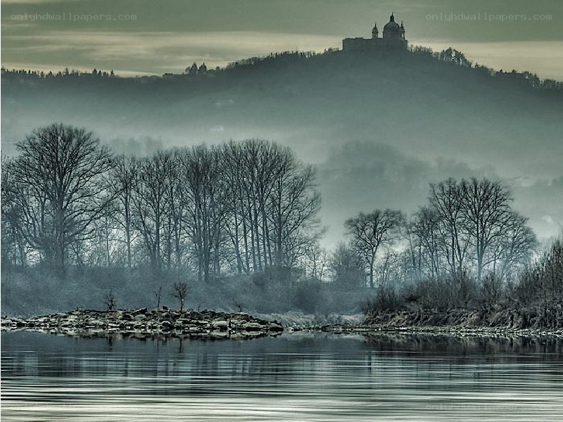 Misty river with hilltop castle