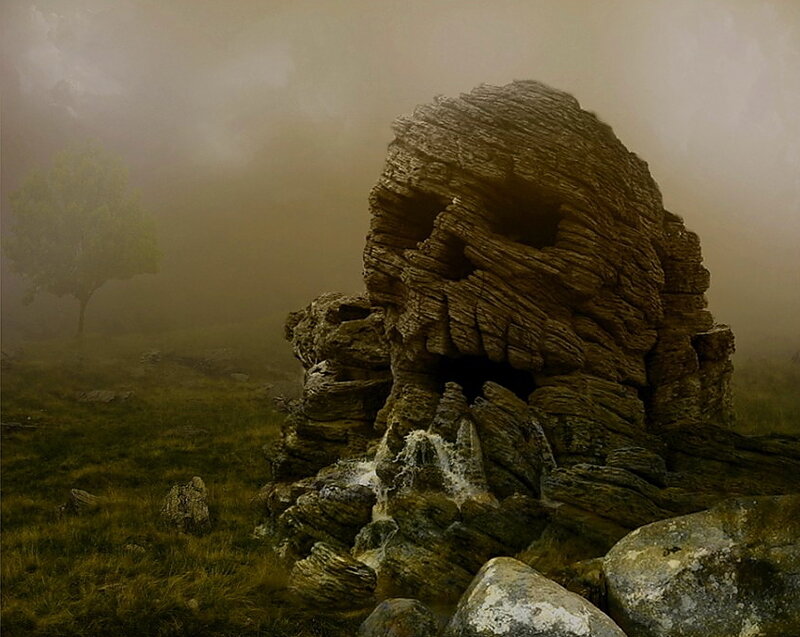 Misty rock formation in a field