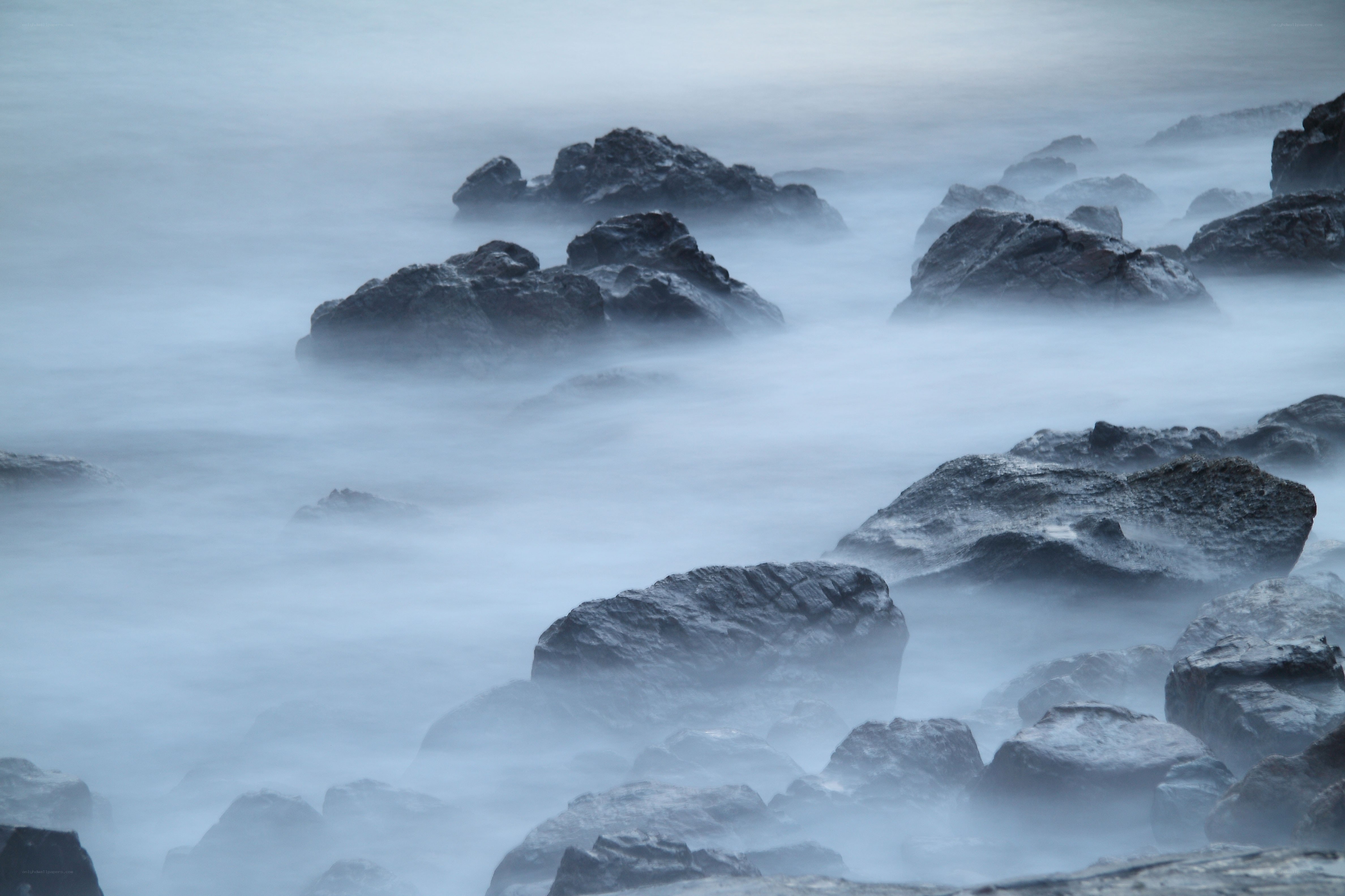 Misty rocks at the shore