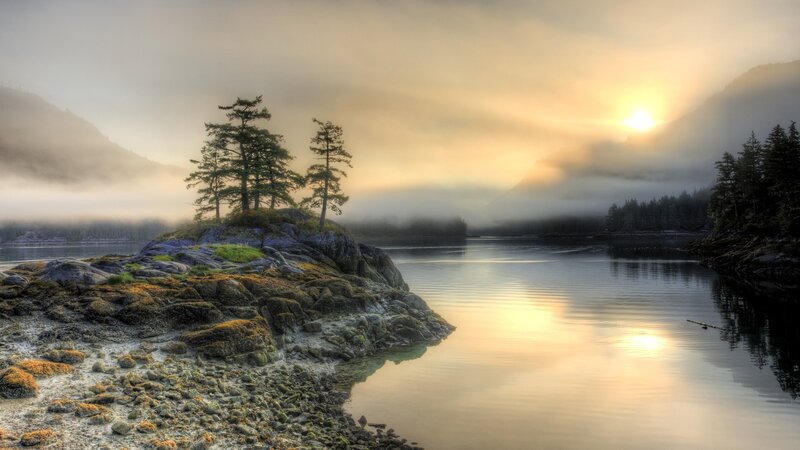 Misty sunrise over a rocky island