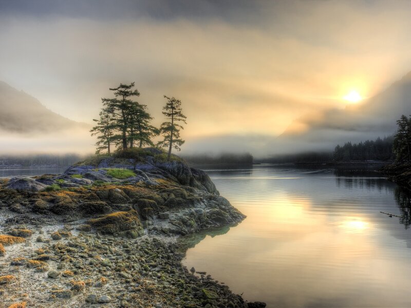 Misty sunrise over a rocky island