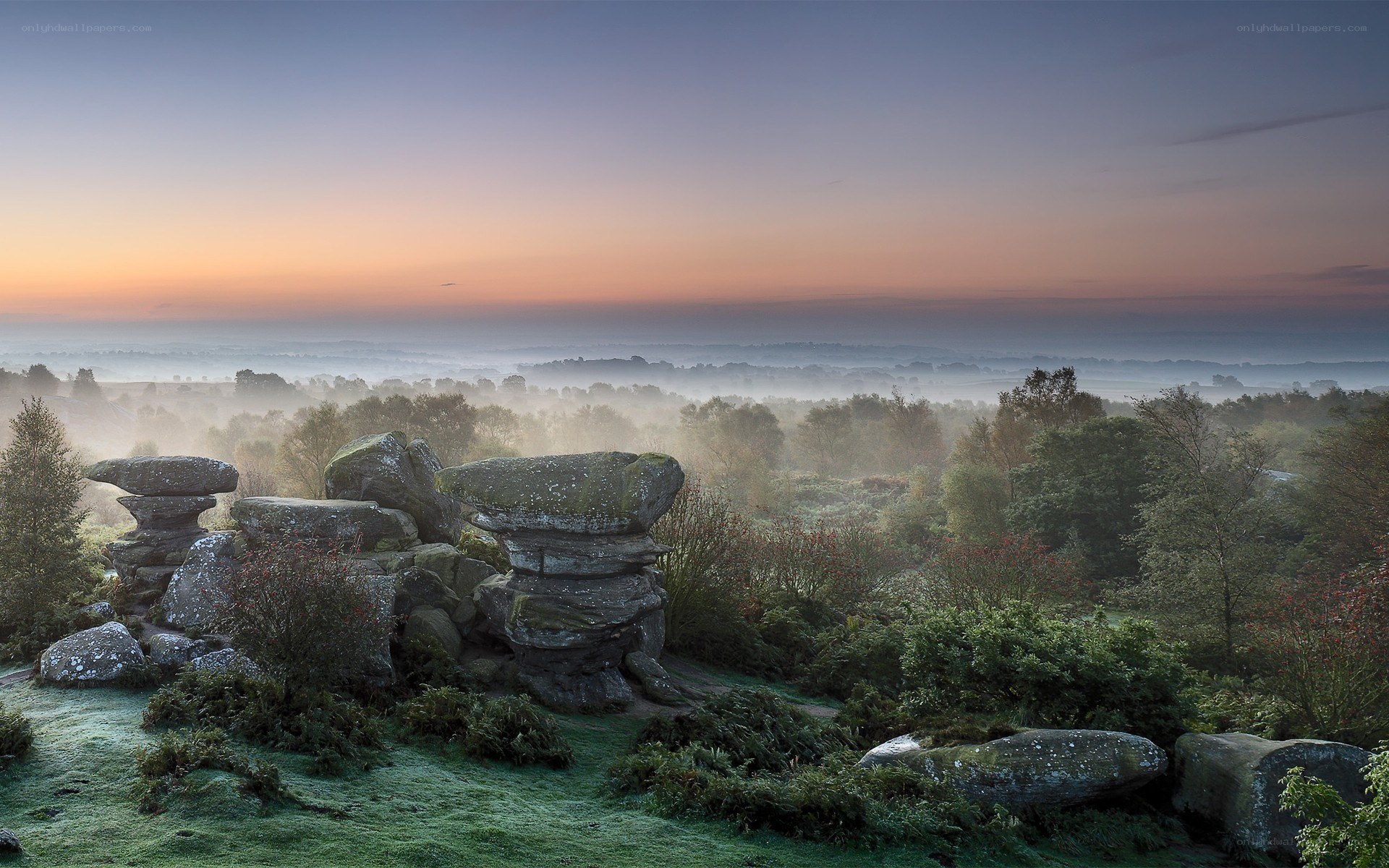 Misty sunrise over rock formations