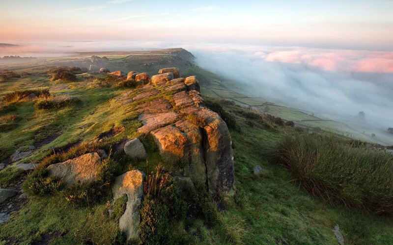 Misty sunrise over rocky hills