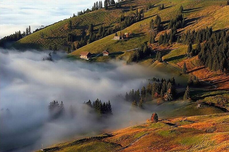 Misty valley with alpine houses