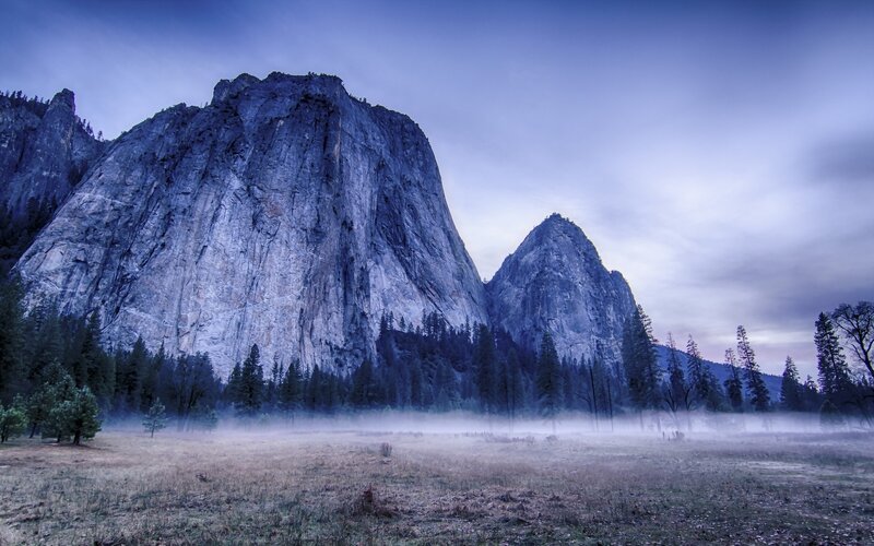 Misty valley with granite cliffs