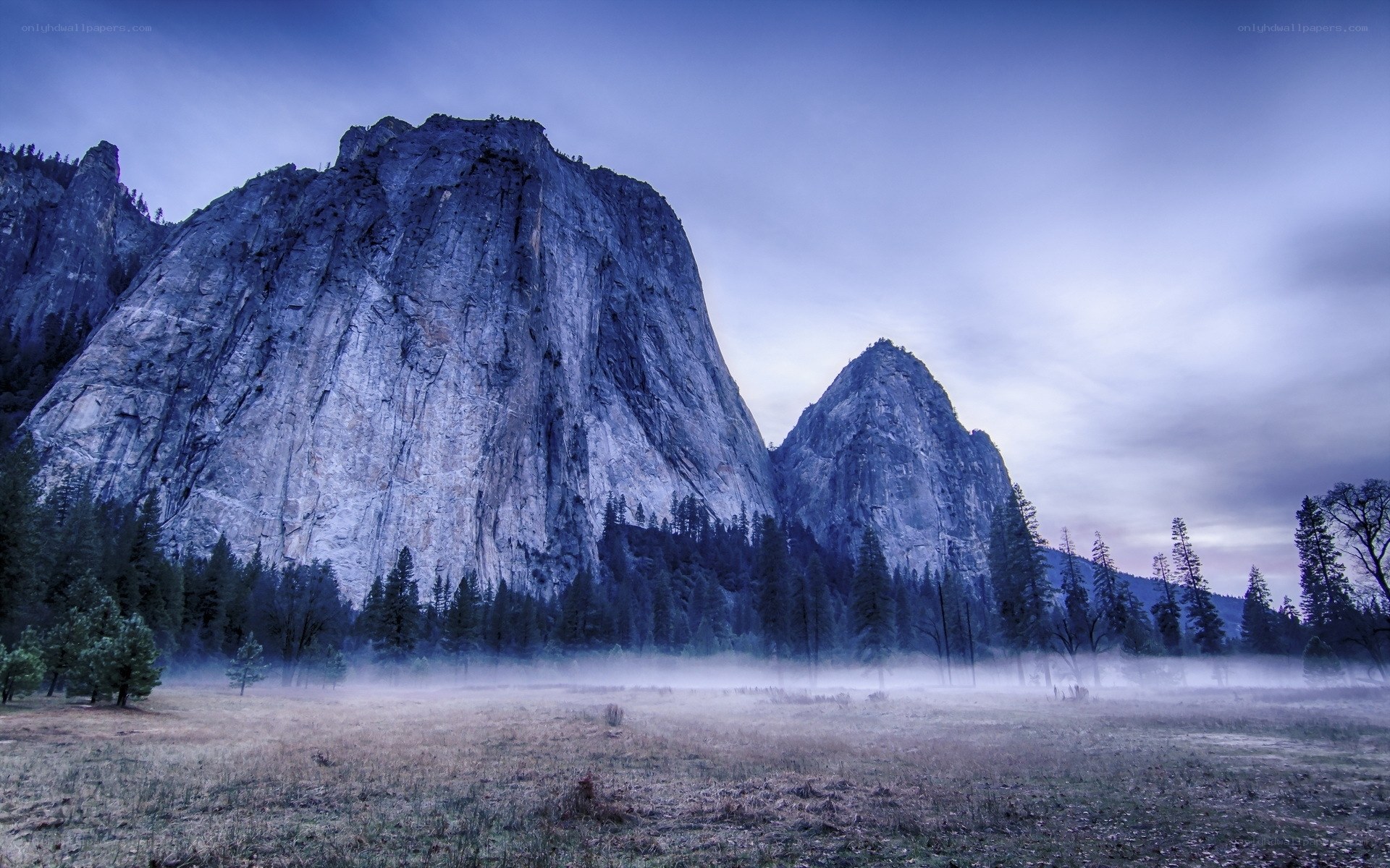 Misty valley with granite cliffs