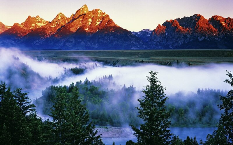 Misty valley with mountain peaks