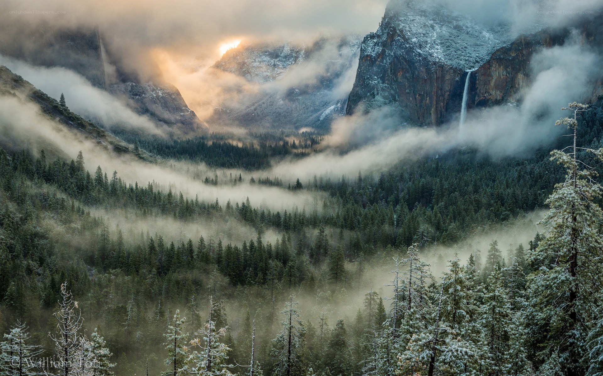 Misty valley with waterfall