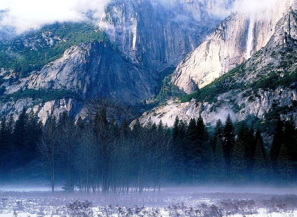 Misty valley with waterfall