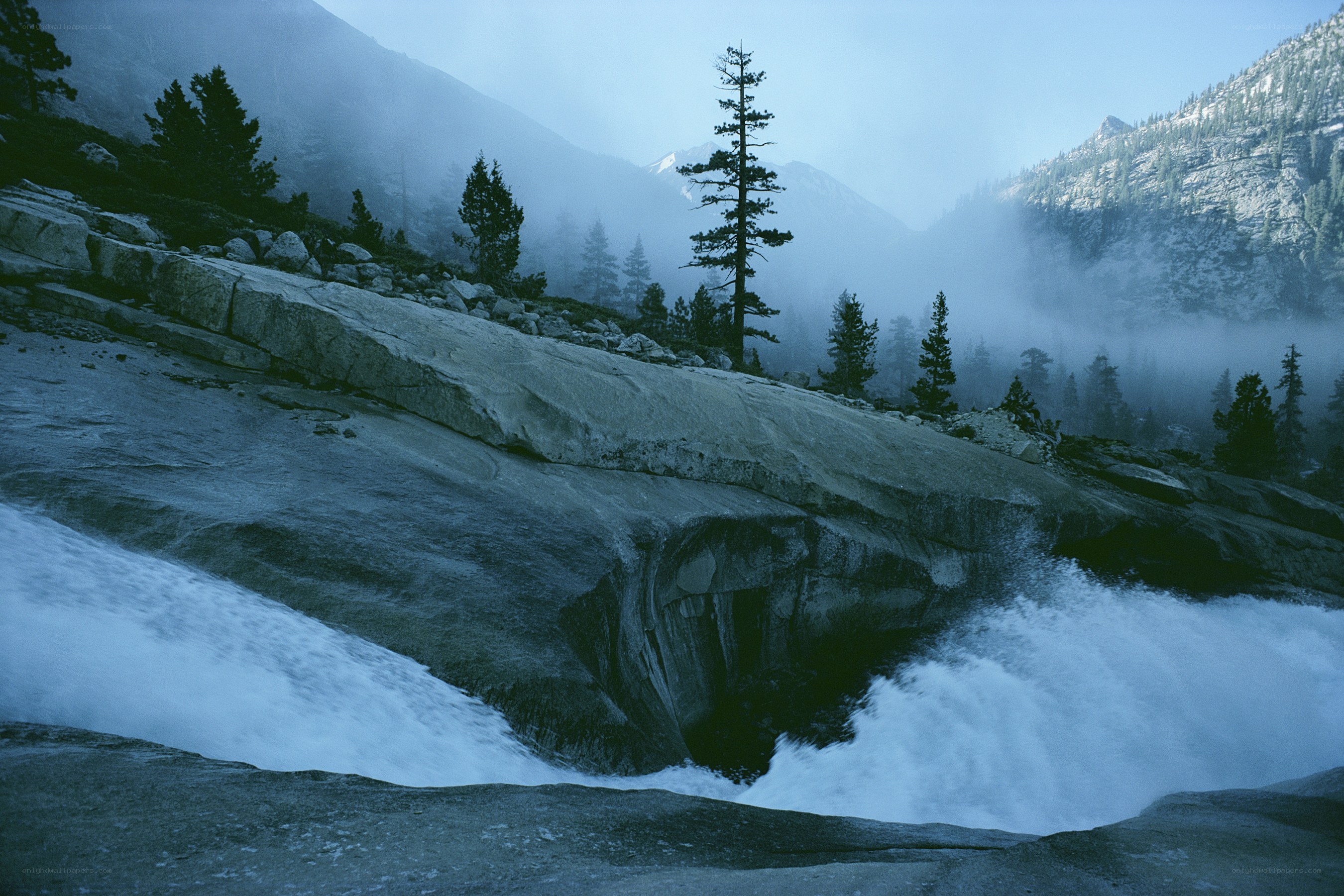 Misty waterfall in mountain valley