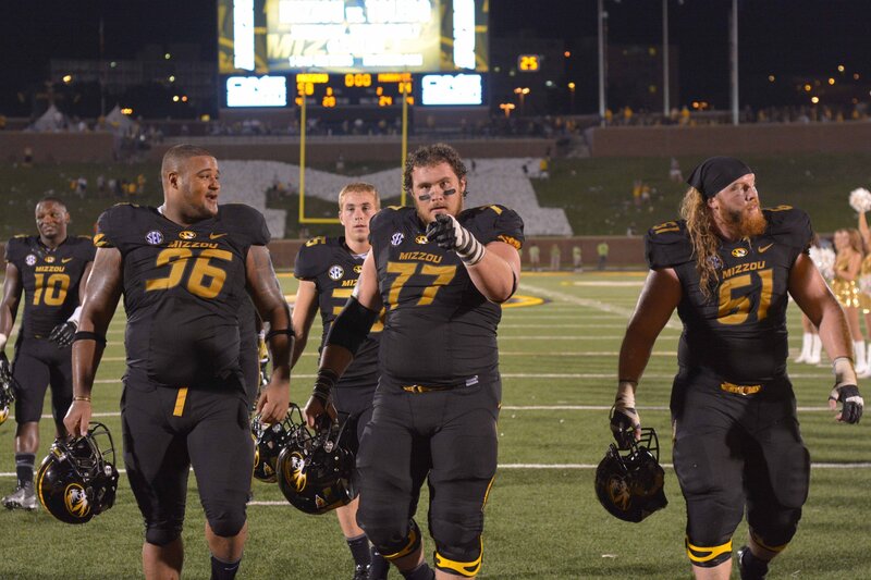 Mizzou football players on field