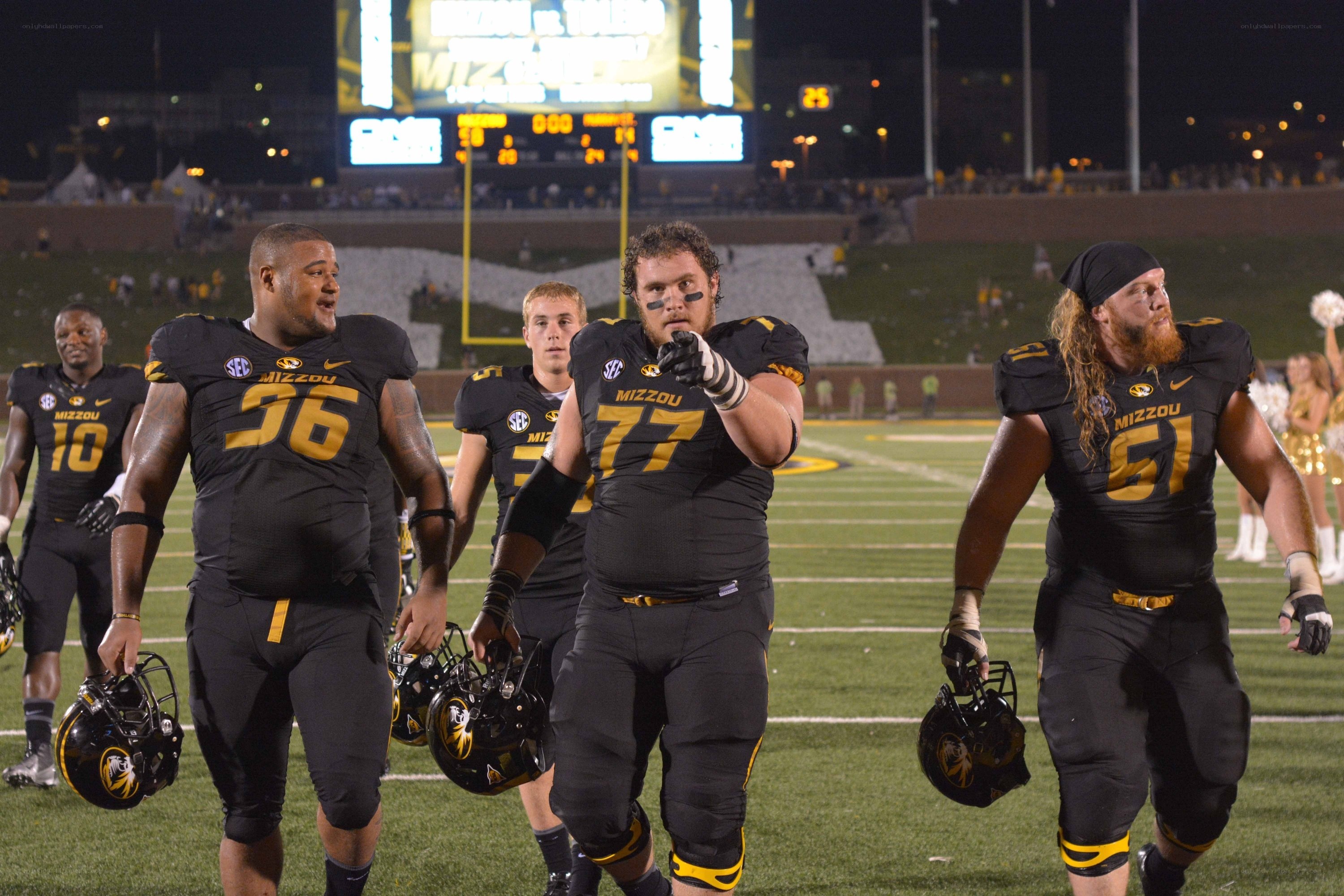 Mizzou football players on field