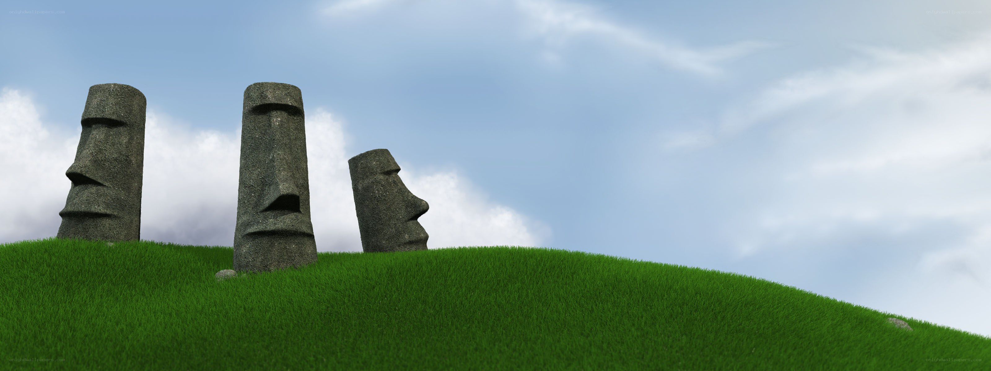 Moai statues on a grassy hill