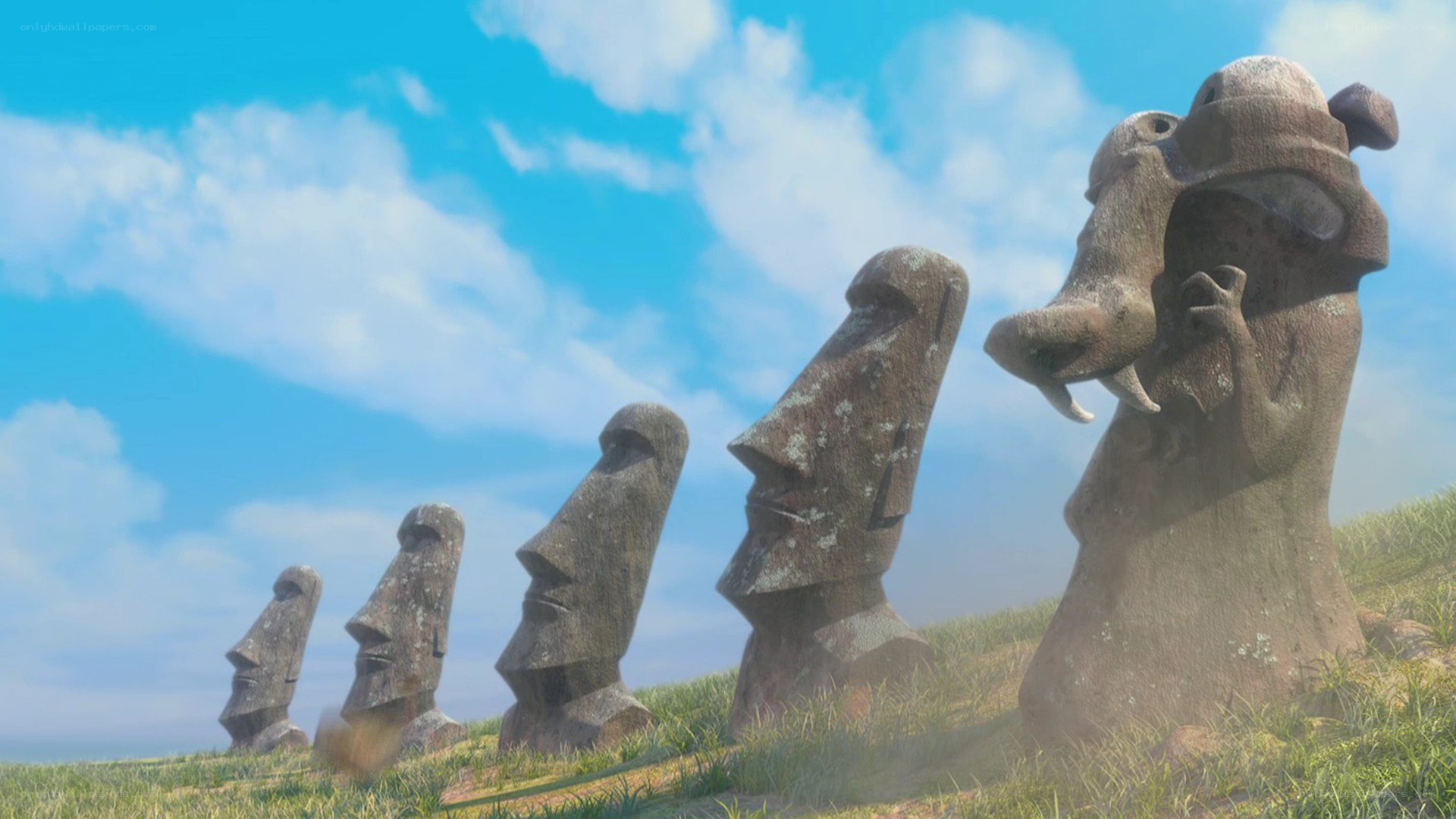 Moai statues on a grassy hill