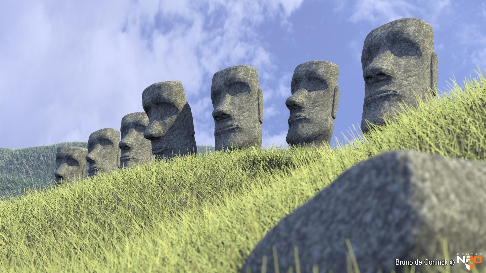 Moai statues on grassy hill