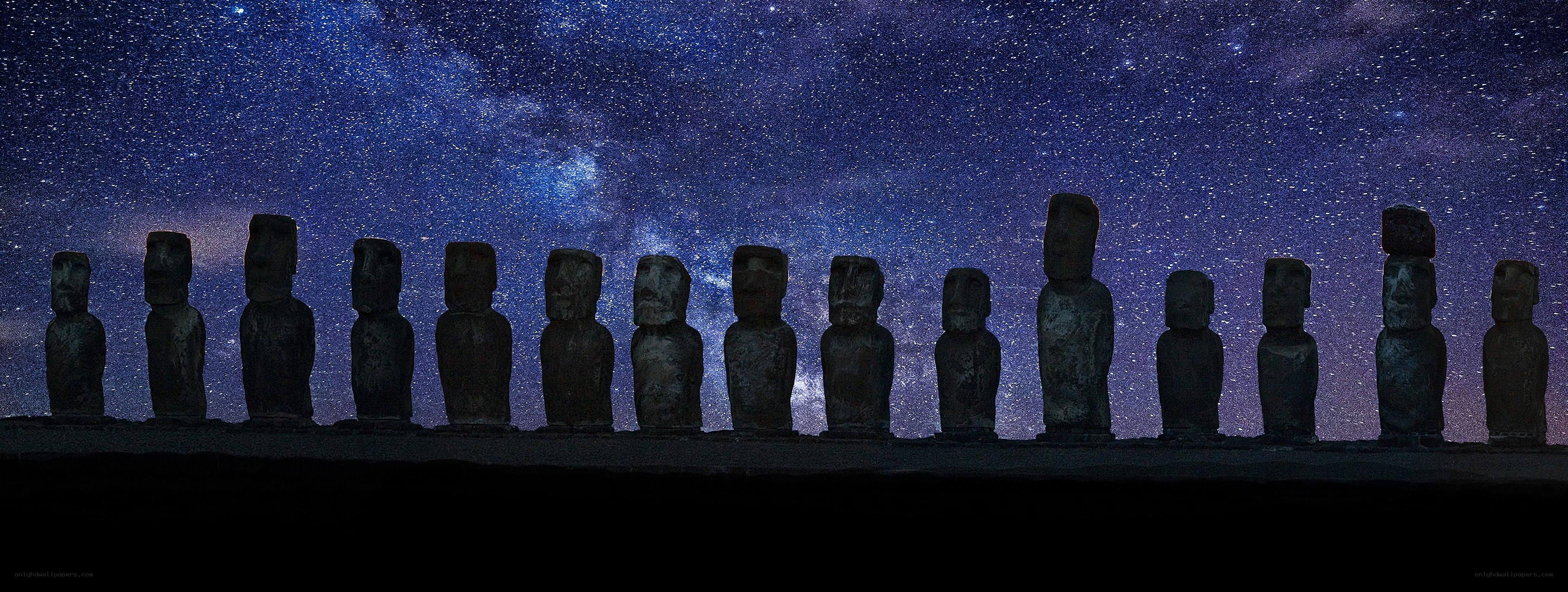 Moai statues under starry sky