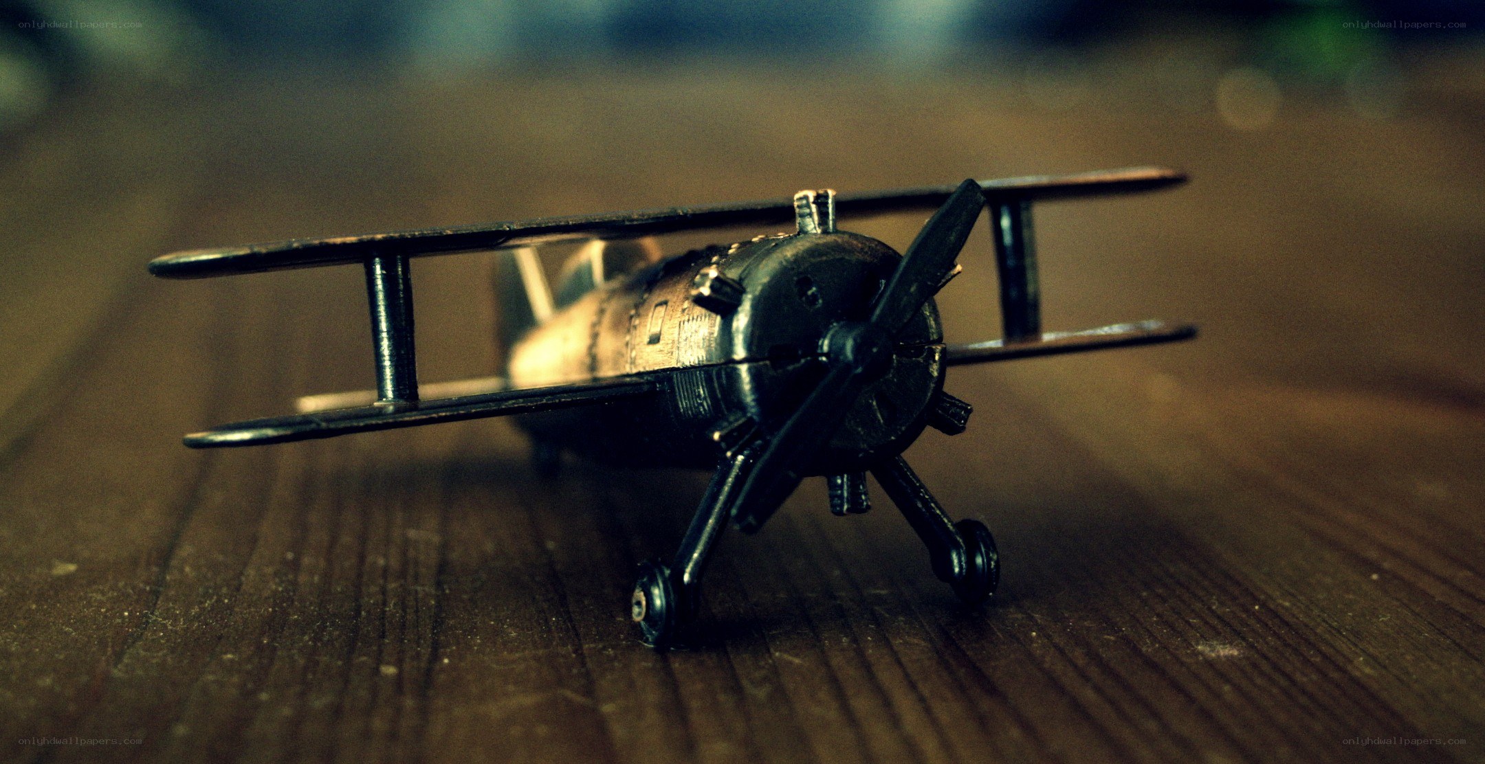 model biplane on wooden surface