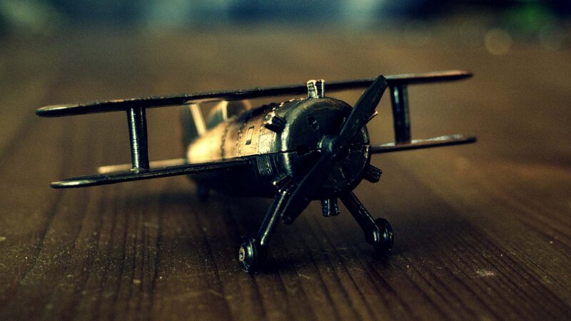 model biplane on wooden surface