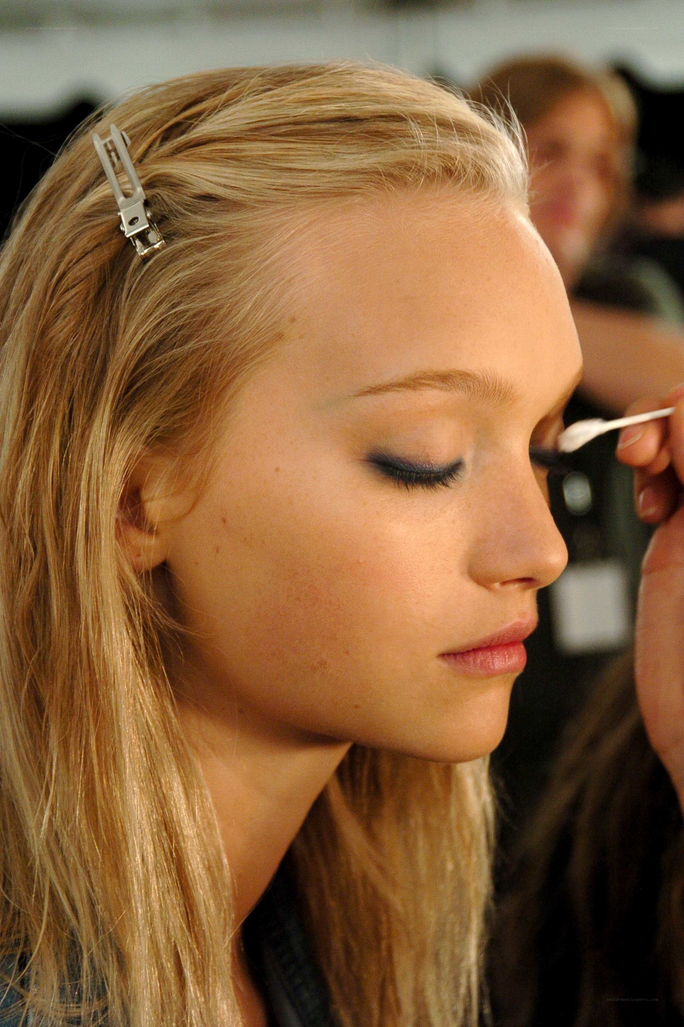 model getting makeup applied