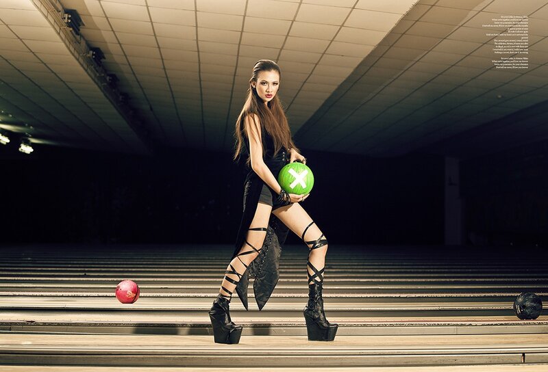 Model holding bowling ball