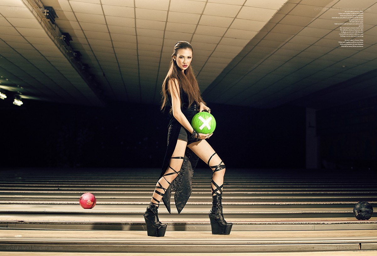 Model holding bowling ball