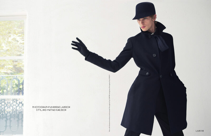 model in black coat and hat