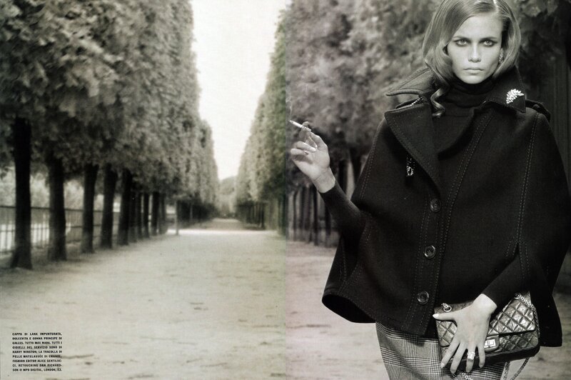 model in black coat smoking