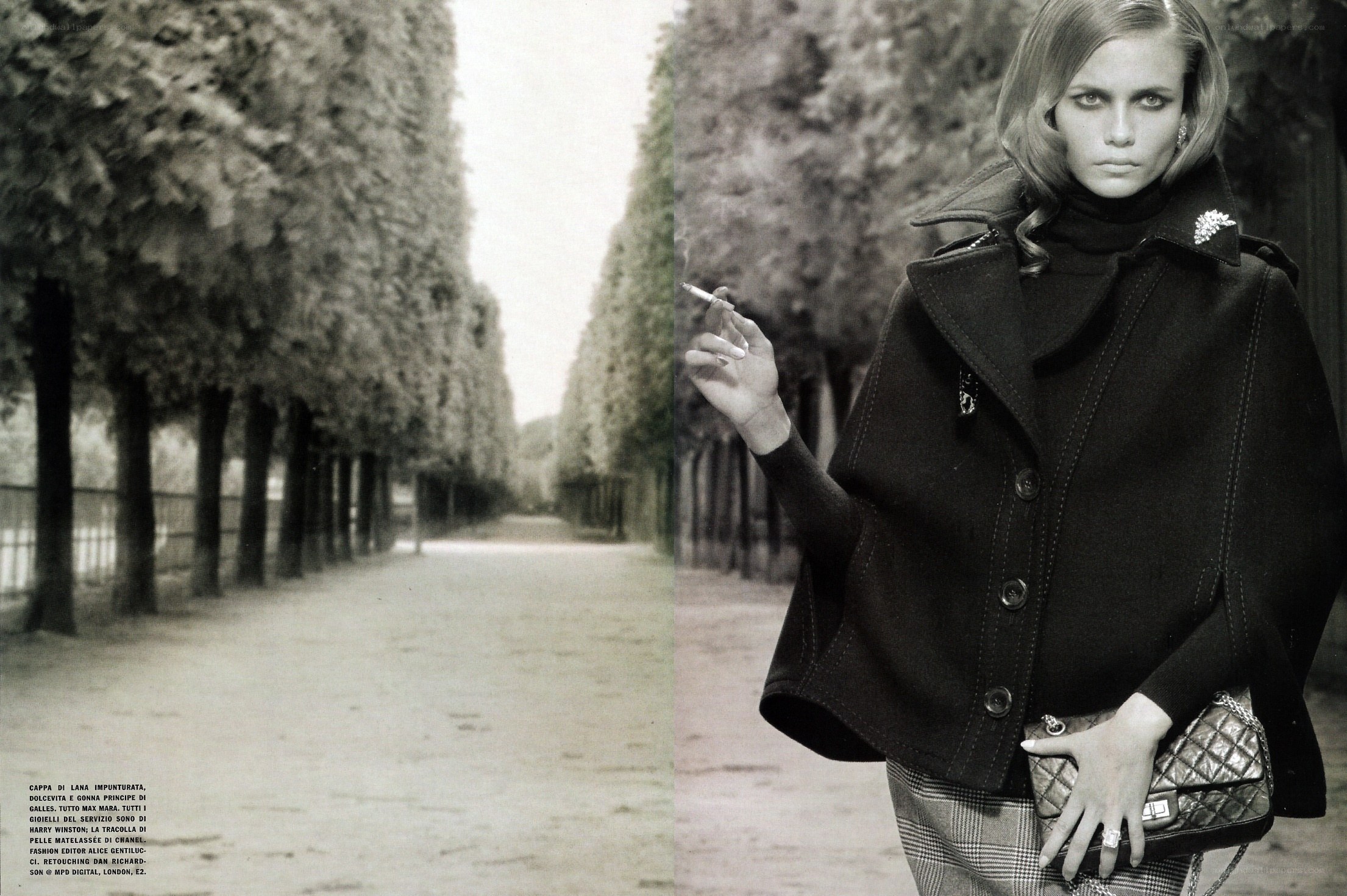 model in black coat smoking