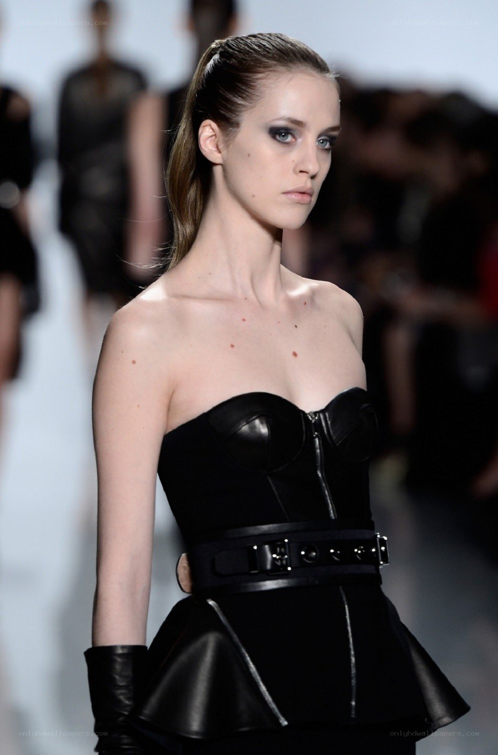 Model in black strapless dress