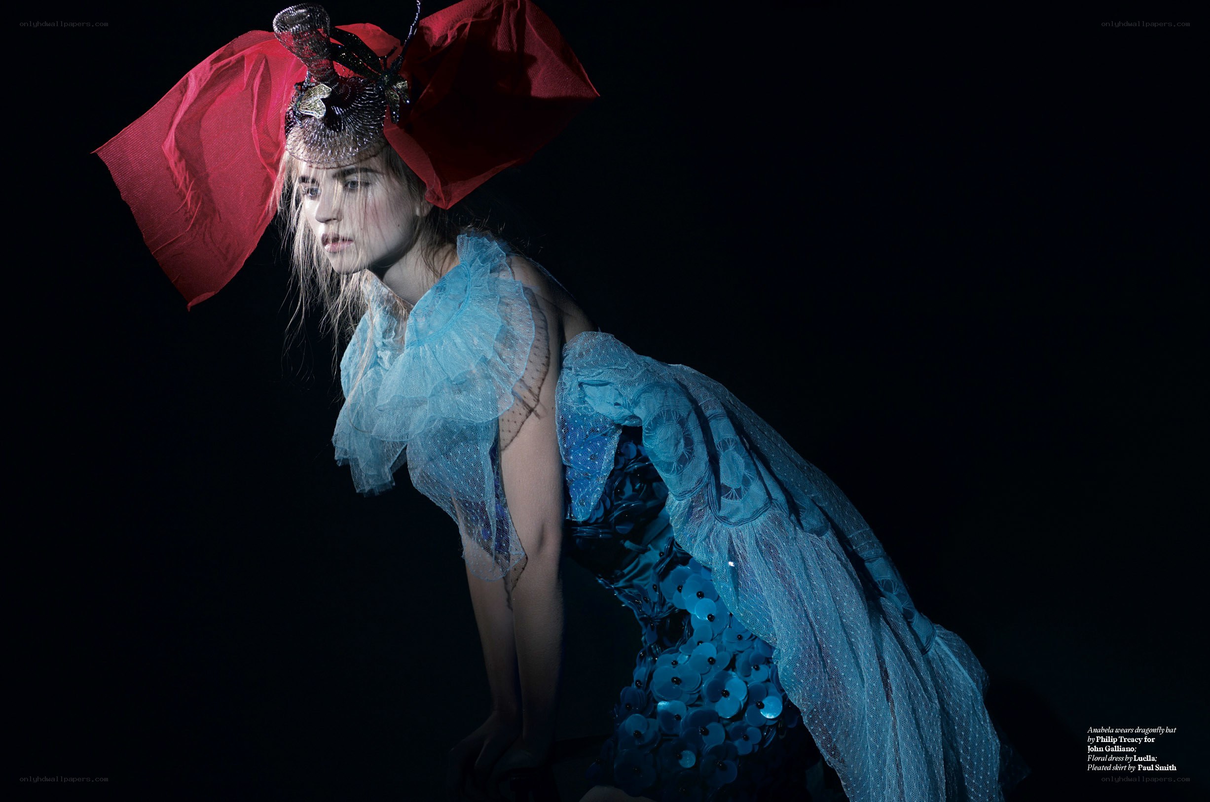 model in blue dress and red hat