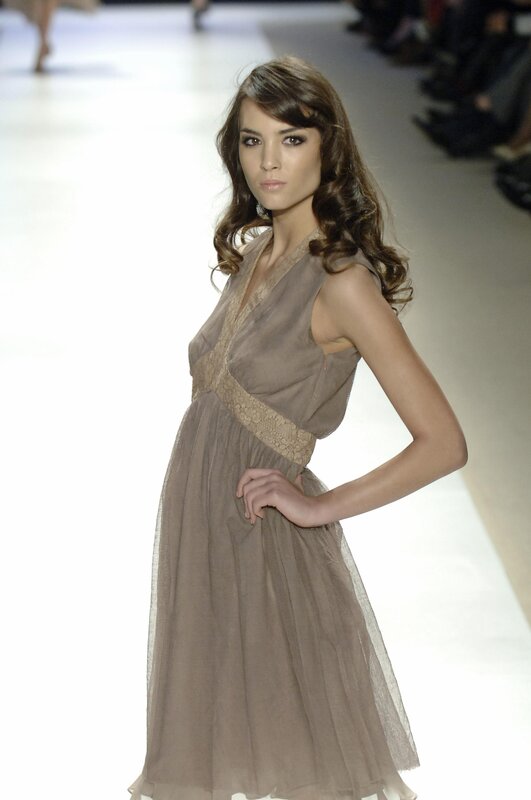 model in brown dress on runway