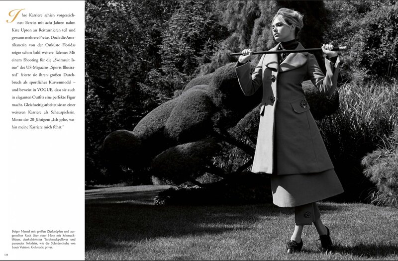 model in coat with stick