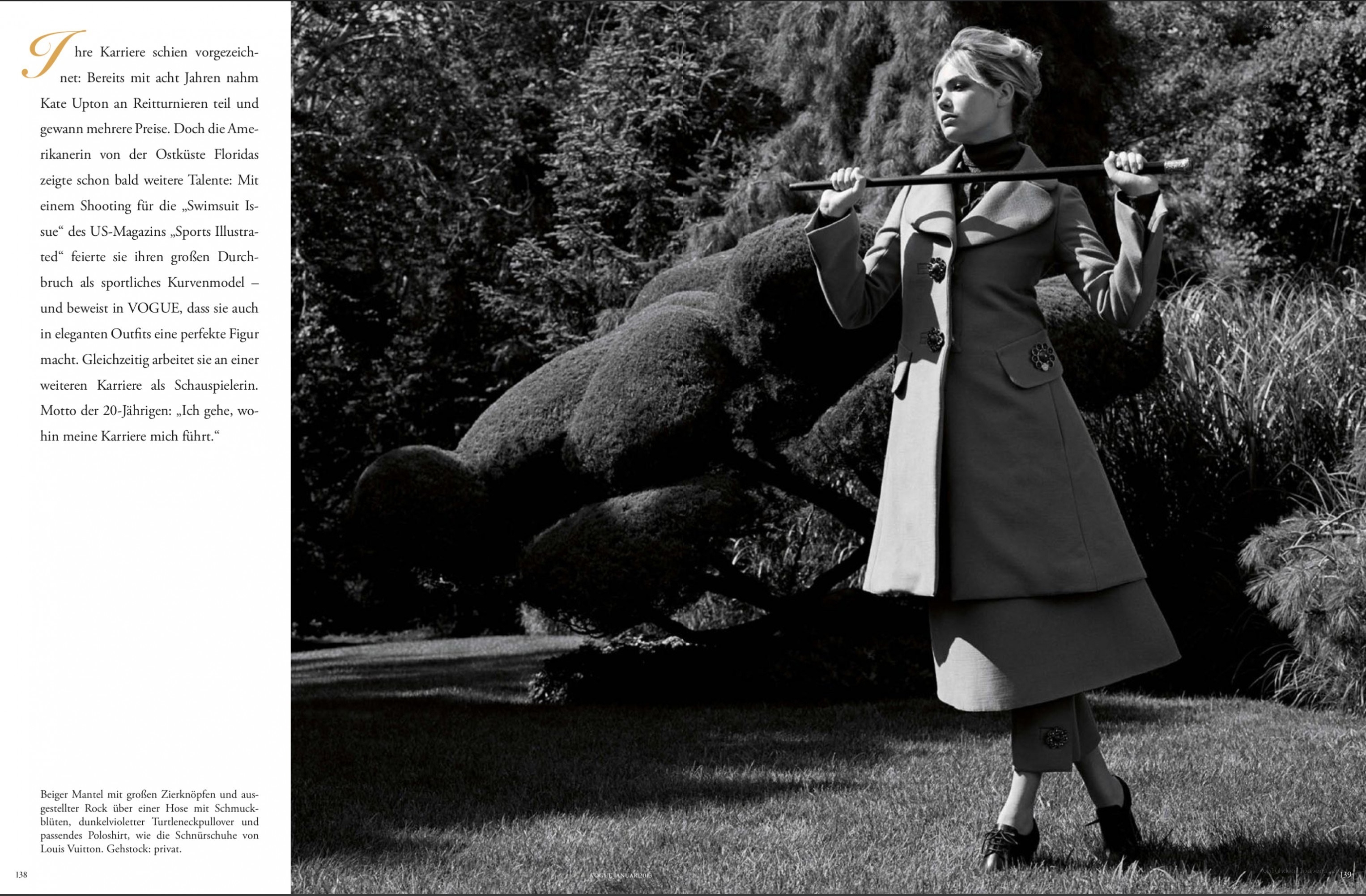 model in coat with stick