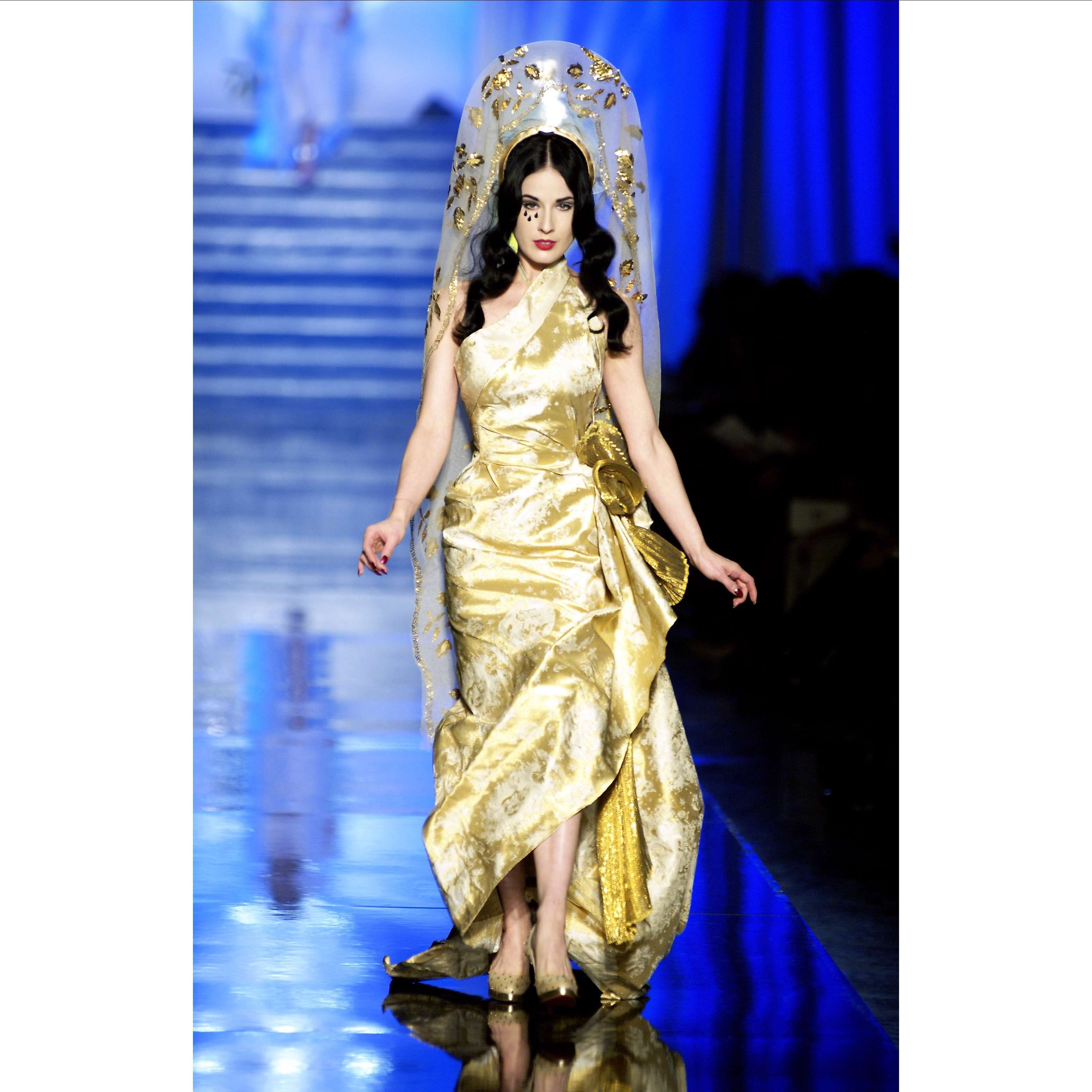 model in gold gown on runway