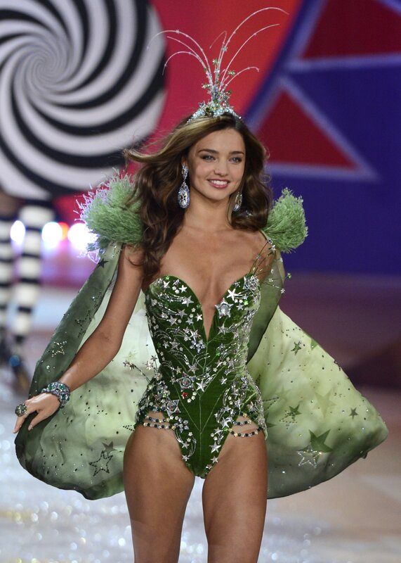 Model in green costume on runway
