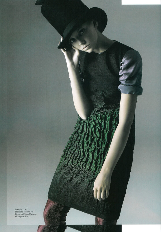 model in green dress and top hat