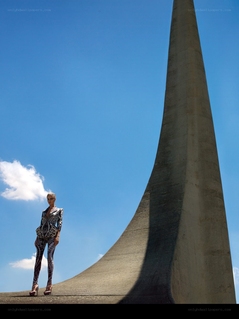 Model in patterned suit near monument
