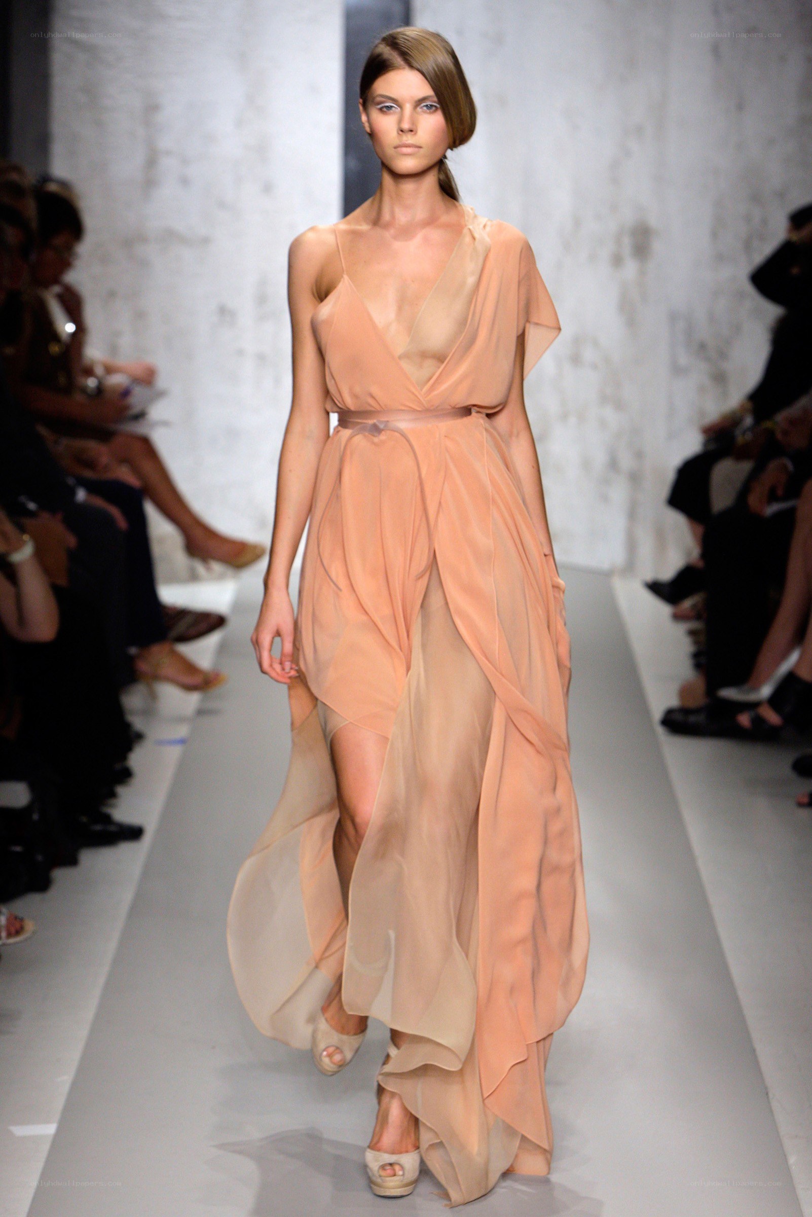 Model in peach gown on runway