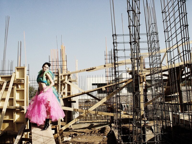 Model in pink dress at construction site