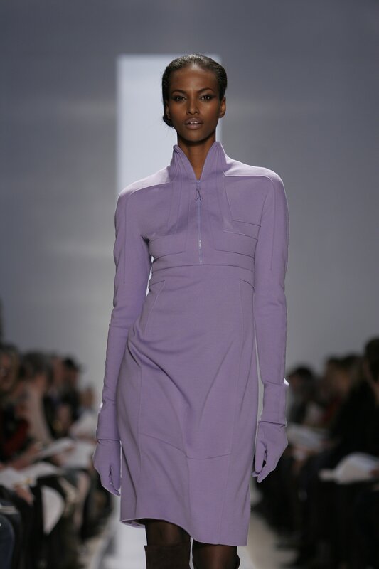 model in purple dress on runway