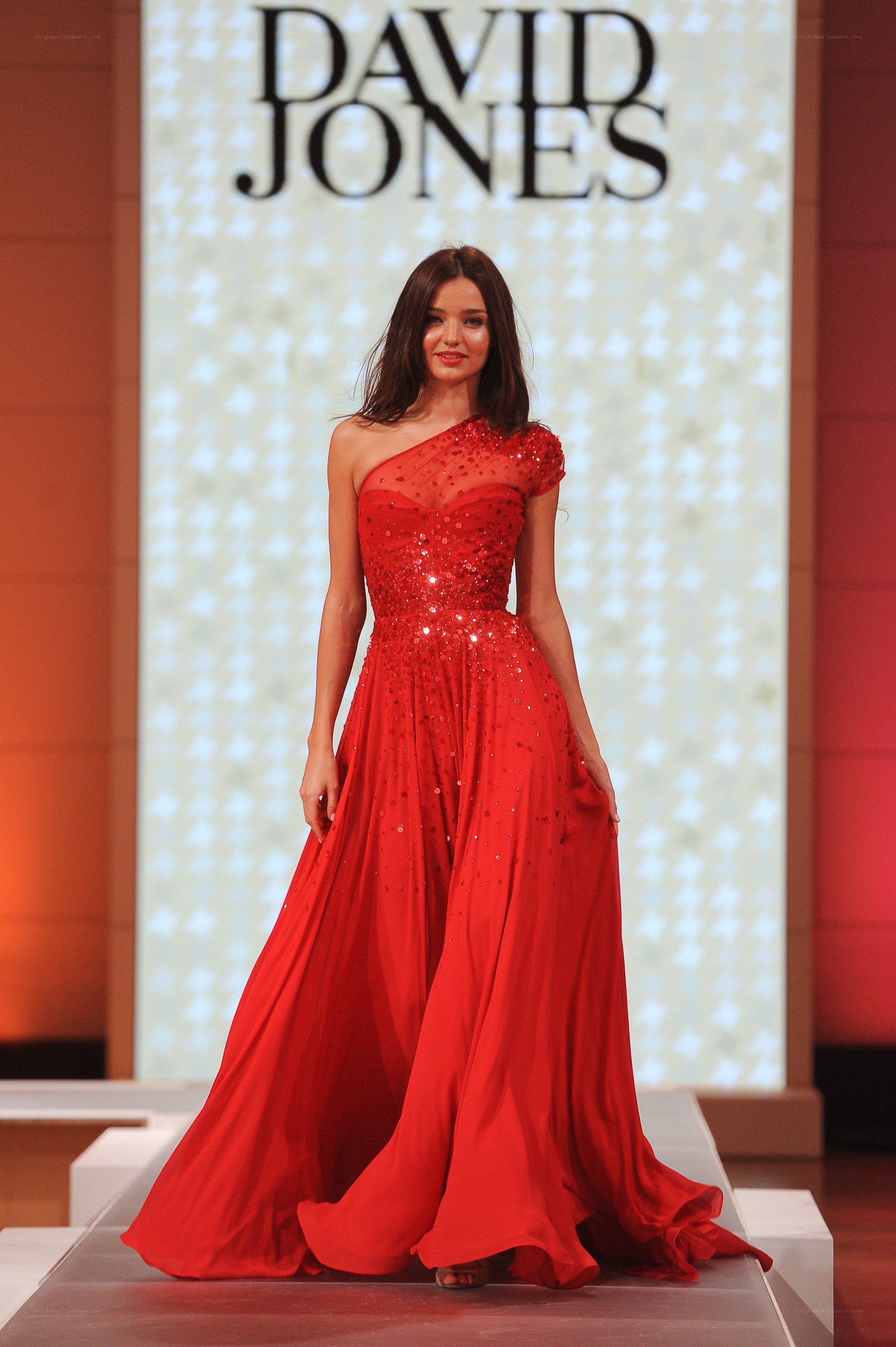 Model in red gown on runway