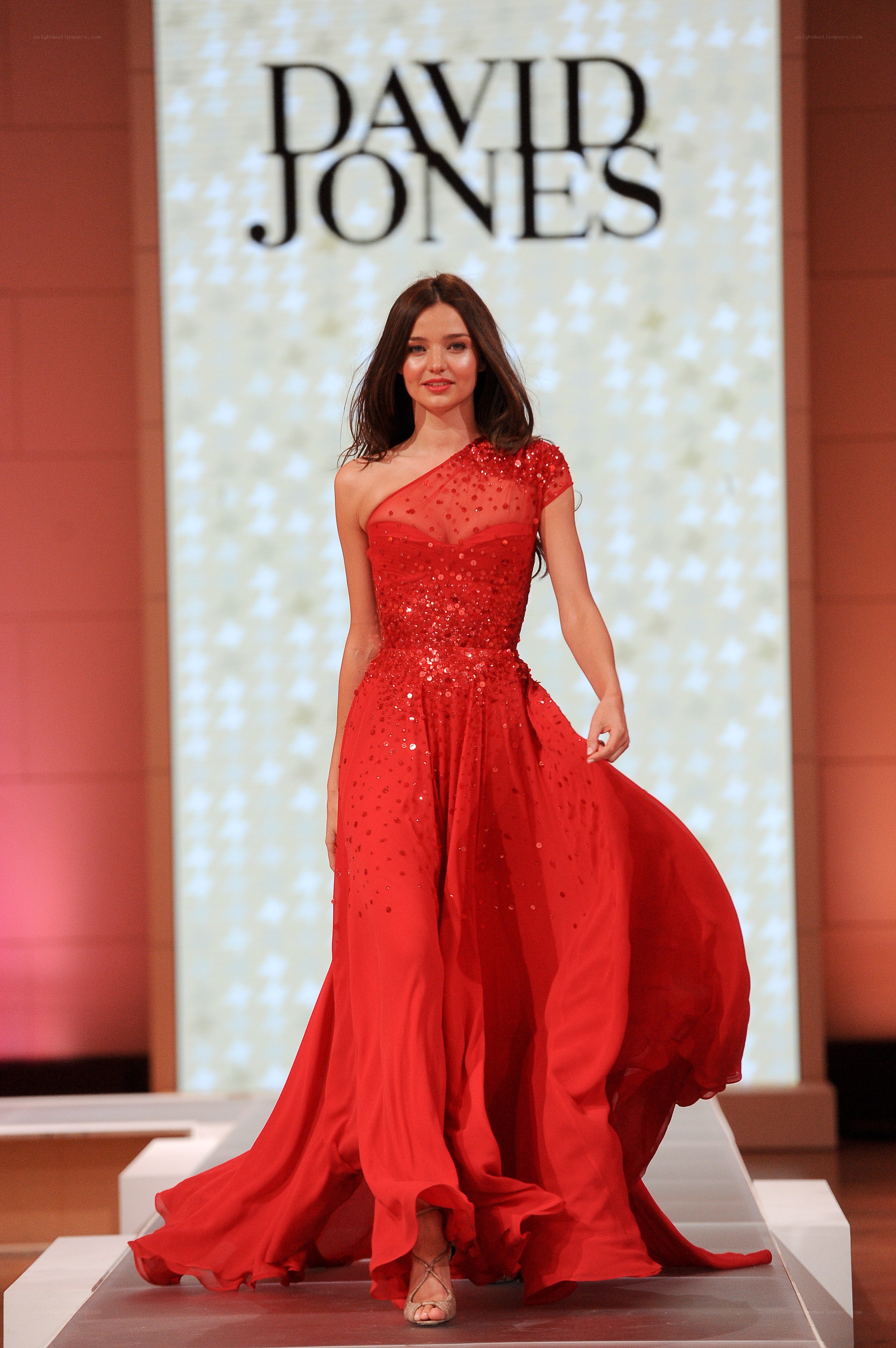 Model in red gown on runway