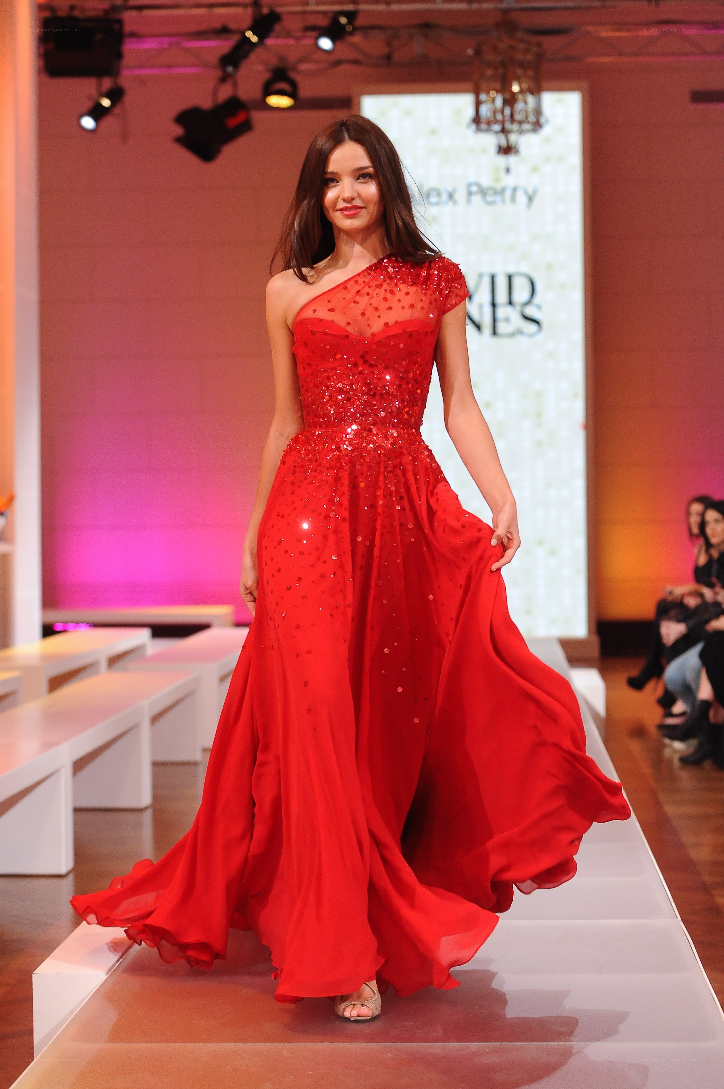 Model in red gown on runway