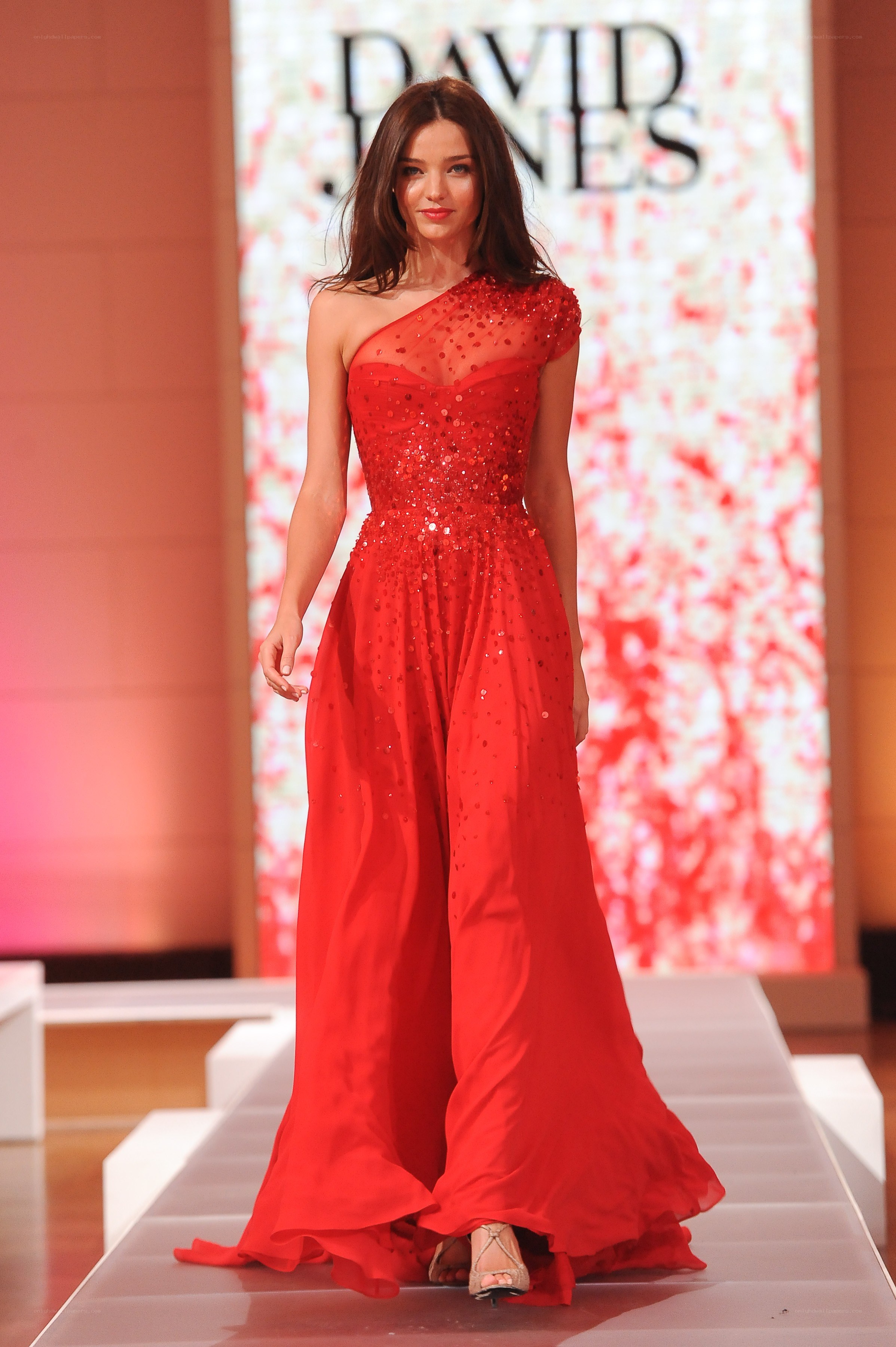 Model in red gown on runway