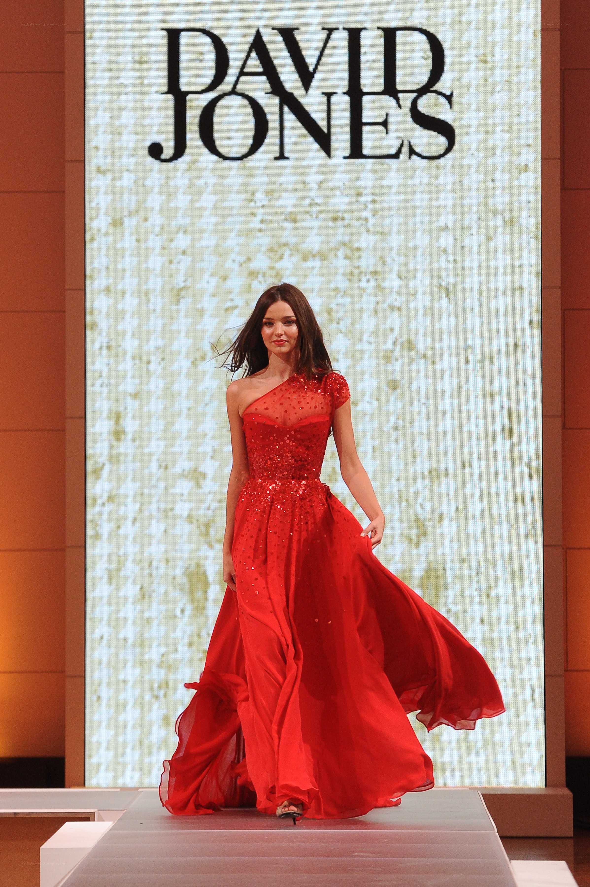 Model in red gown on runway