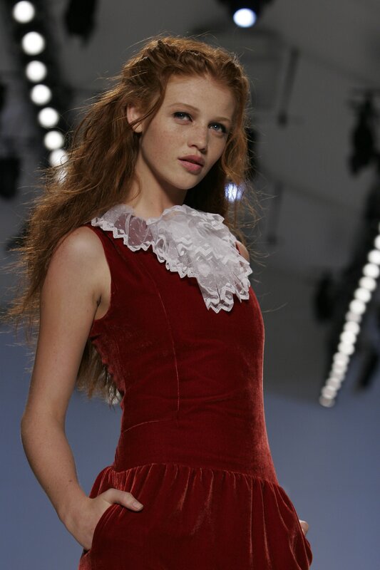 Model in red velvet dress